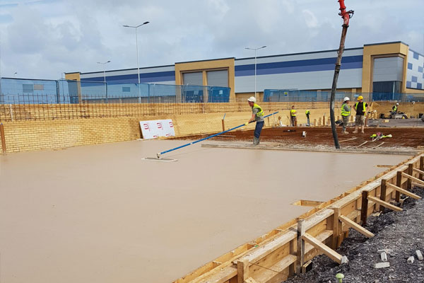 Concrete being poured and levelled in Wrexham